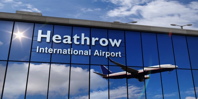 Photo of London Heathrow international airport sign with jet flying overhead