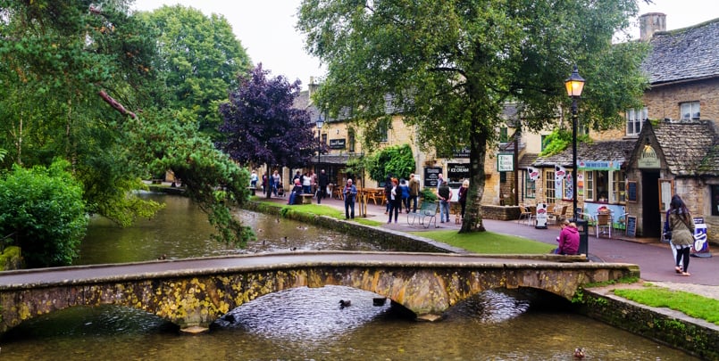 BOURTON-ON-THE-WATER, ENGLAND - SEPTEMBER 5, 2016: Old style city of Bourton on the Water in The Cotswolds know as Area Of Outstanding Beauty (AONB) in United Kingdom