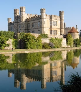A hot air balloon rising over Leeds Castle in Kent England