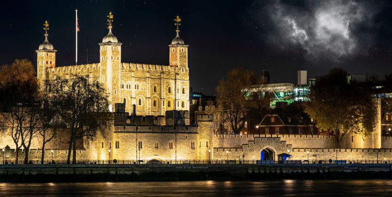 Tower of London overlooking the river Thames at night panoramic